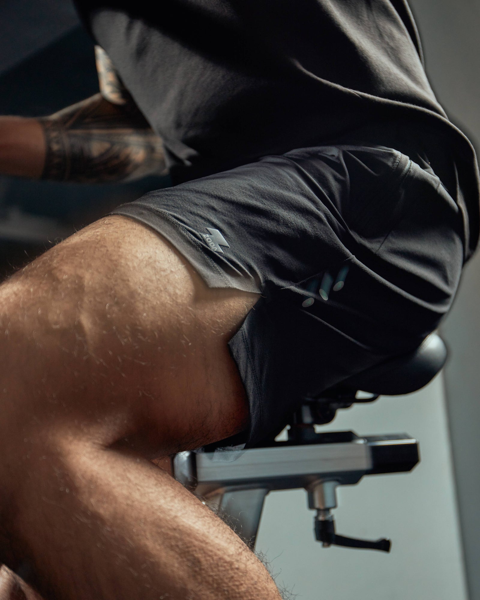 Person using a weight machine in a gym setting Zoda.sg