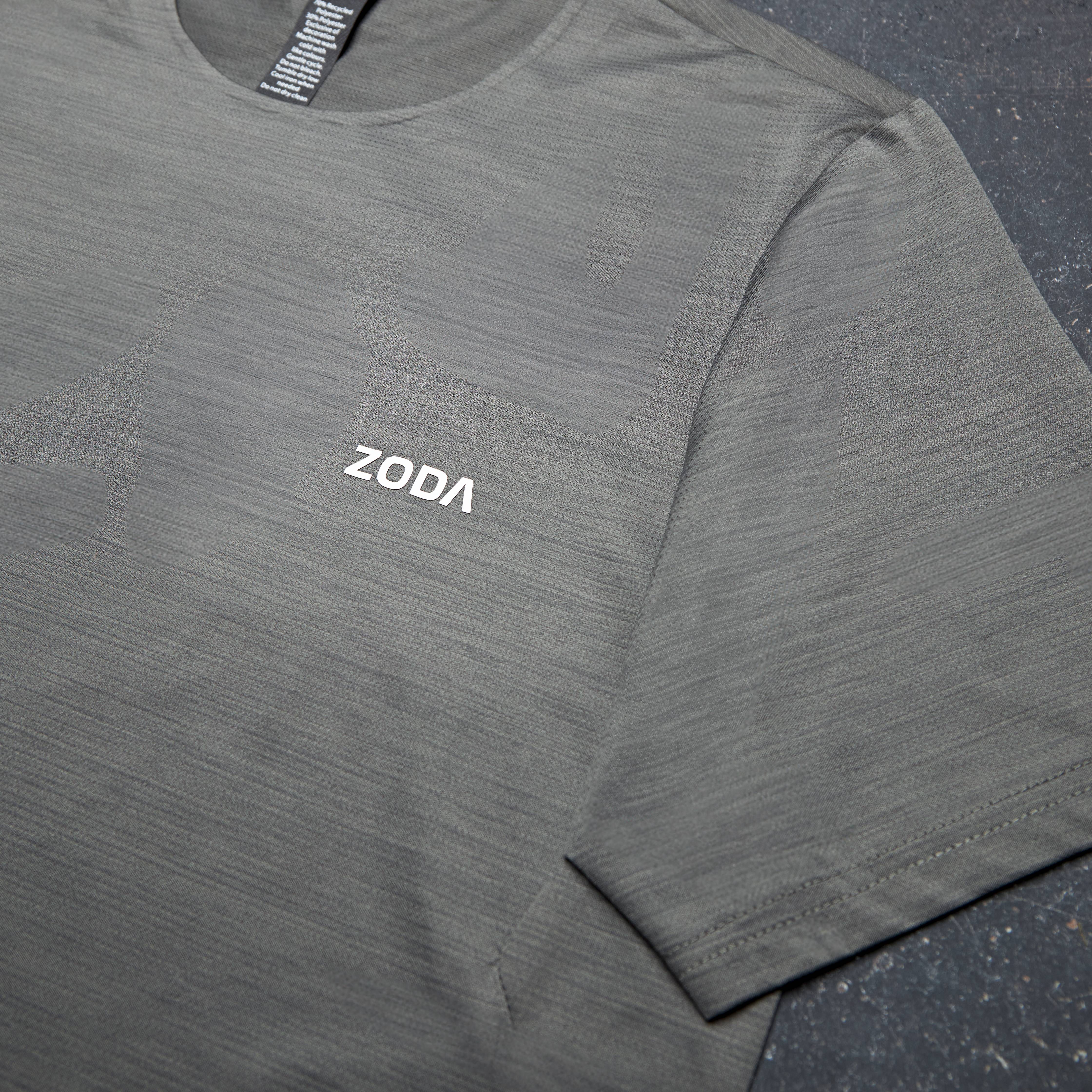 Gray long-sleeve shirt with 'ZODA' logo on a dark surface Zoda.sg