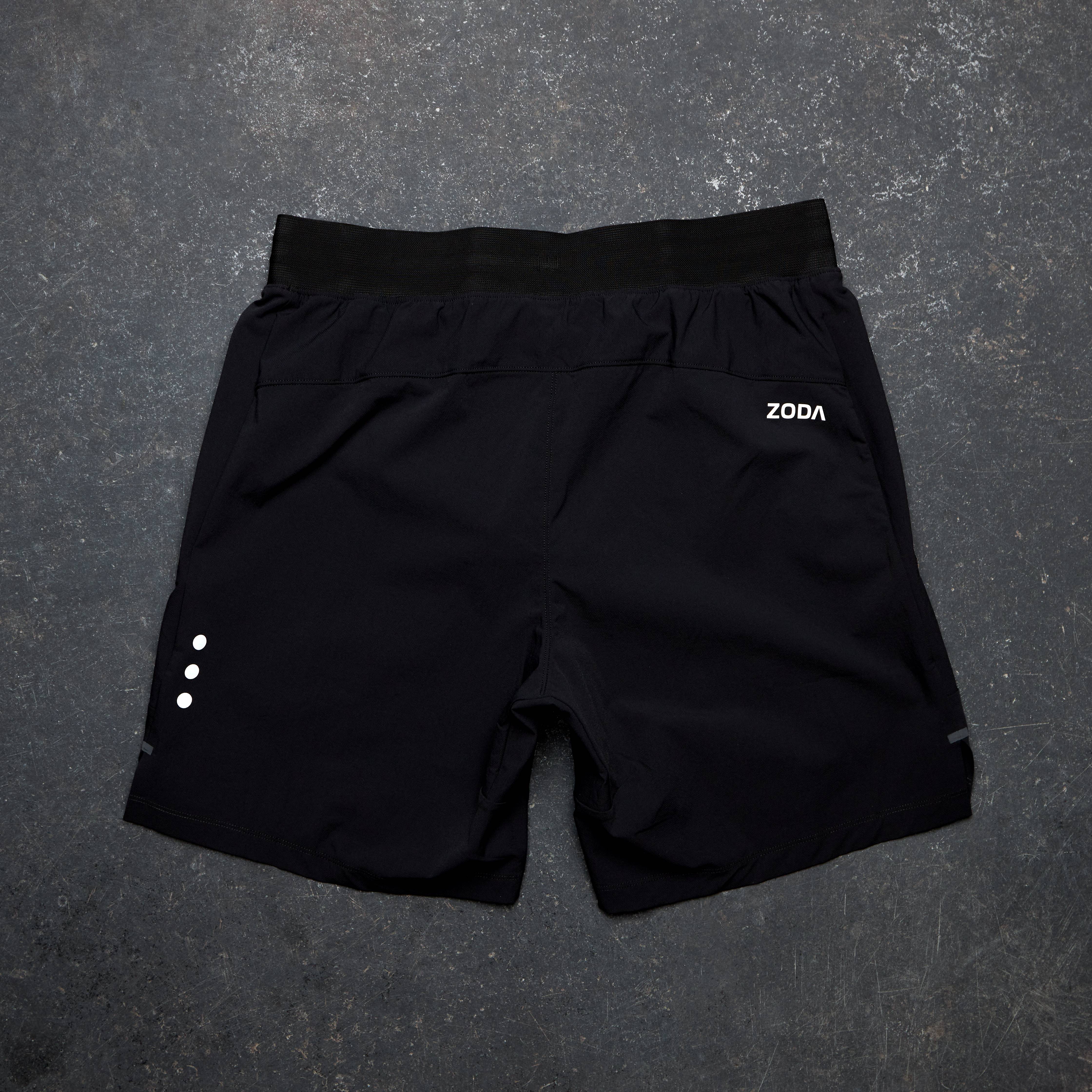 Black shorts with a brand logo on a gray surface Zoda.sg