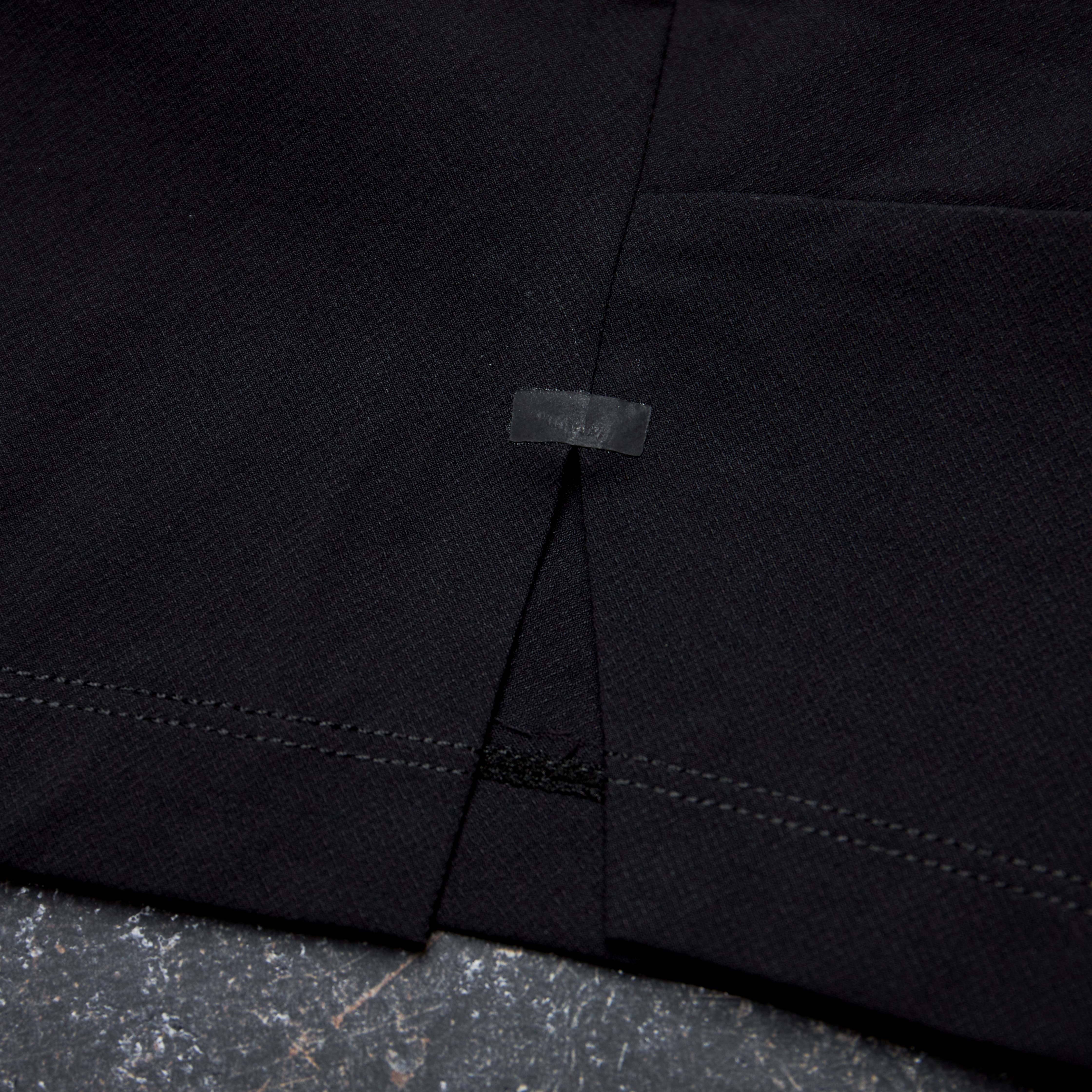 Close-up of a black fabric with stitching detail on a textured surface Zoda.sg