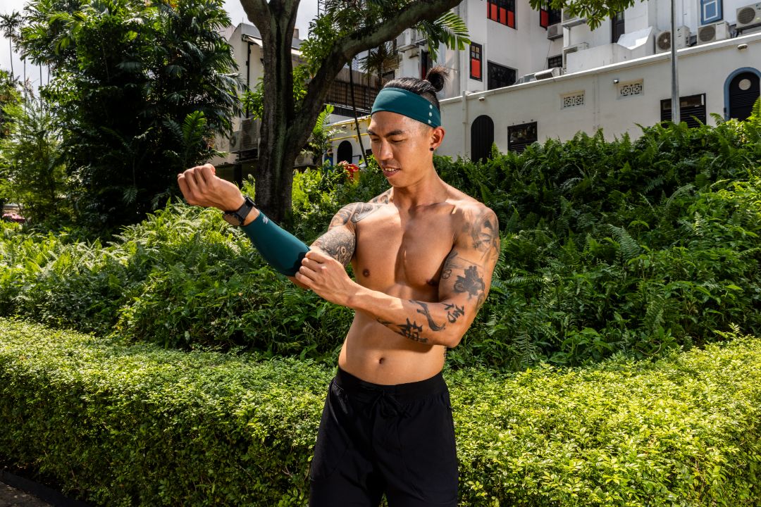 Man with tattoos outdoors in a park-like setting Zoda.sg