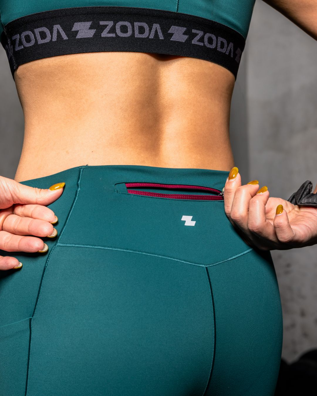 Teal athletic outfit with ZODA branding on a gray background Zoda.sg