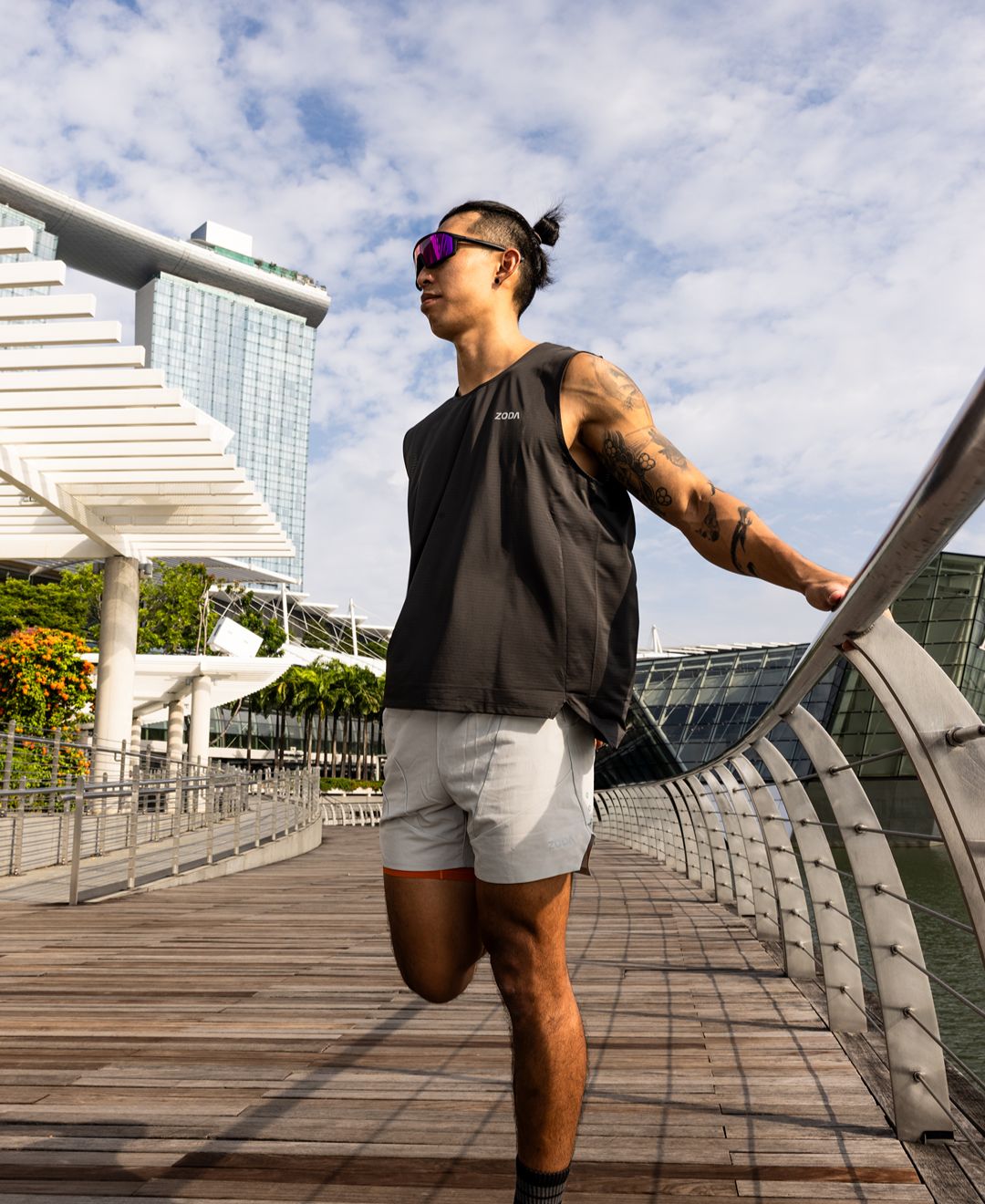 Man walking on a modern bridge with a cityscape in the background Zoda Pulse Collection