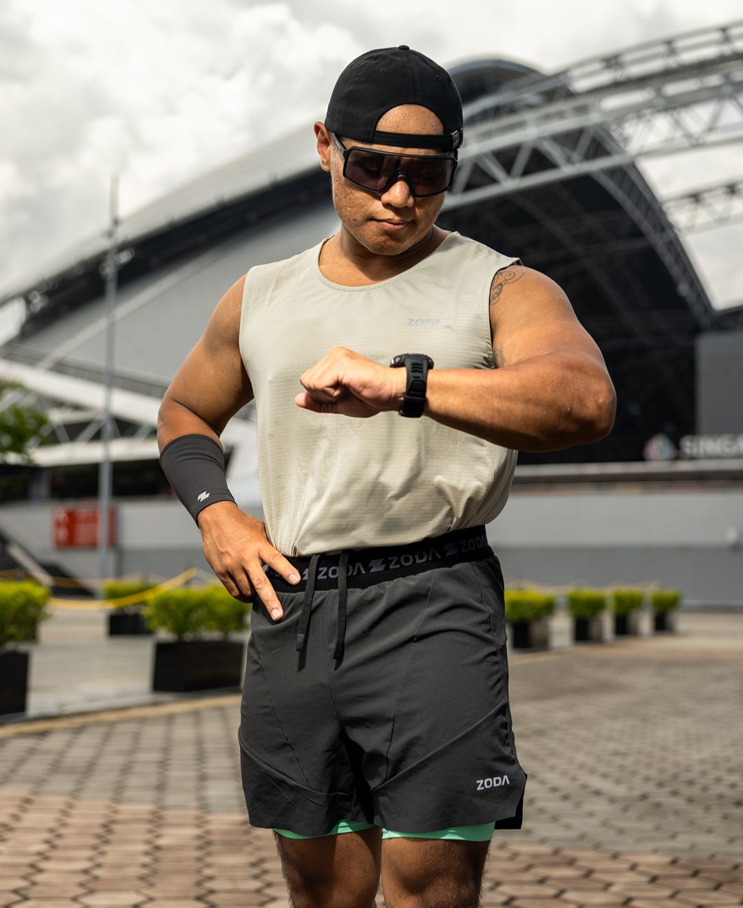 Person wearing athletic gear with a watch, standing outdoors. Zoda.sg pulse collection