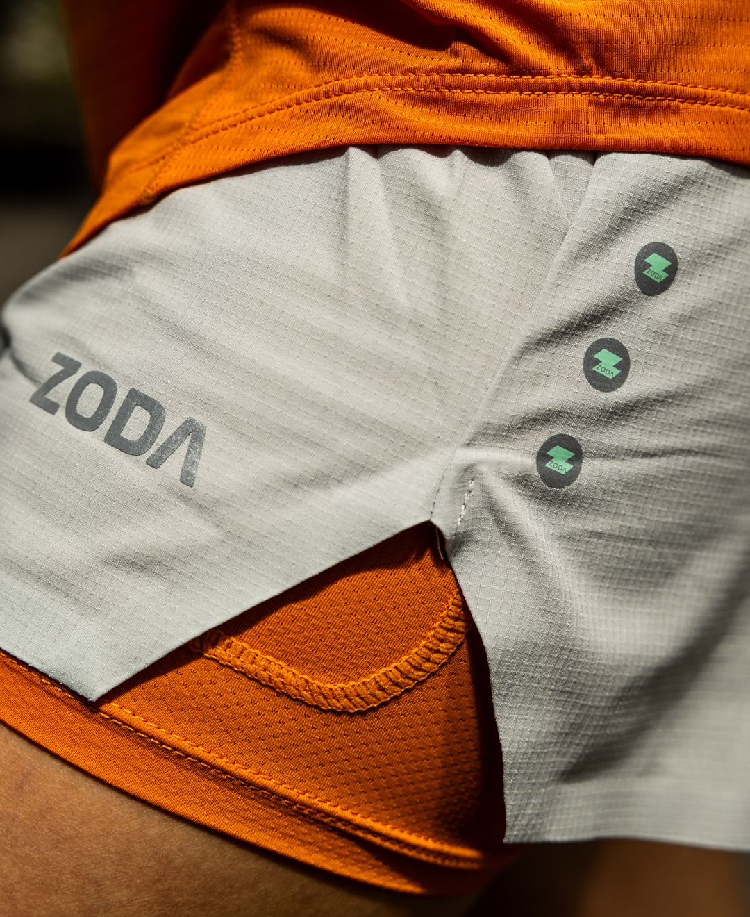 Gray athletic shorts with orange accents and 'Zoda' branding. Training wear - Zoda.sg In it to win it, Singapore