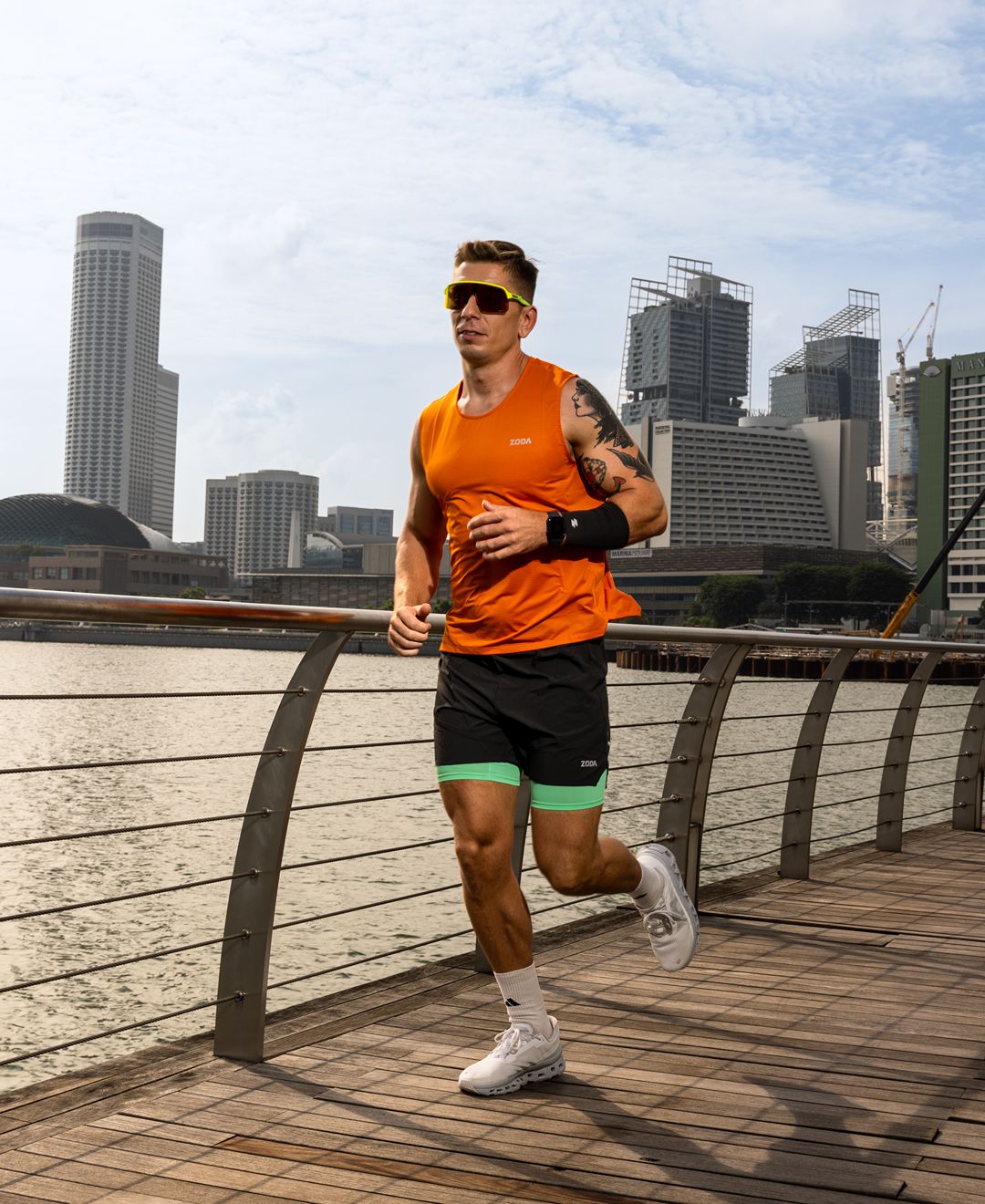 Man running on a wooden path with a city skyline in the background Zoda.sg