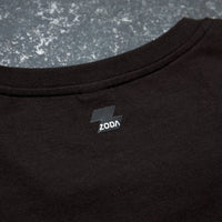 Black t-shirt with a logo on the chest against a gray textured background Zoda.sg