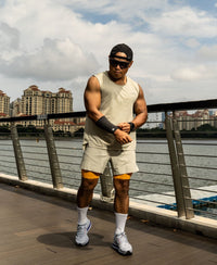 Man in athletic wear standing by a waterfront with buildings in the background Zoda.sg 